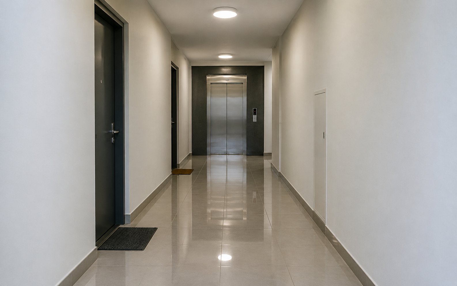 Home A clean communal hallway with tiled floor inside an apartment block