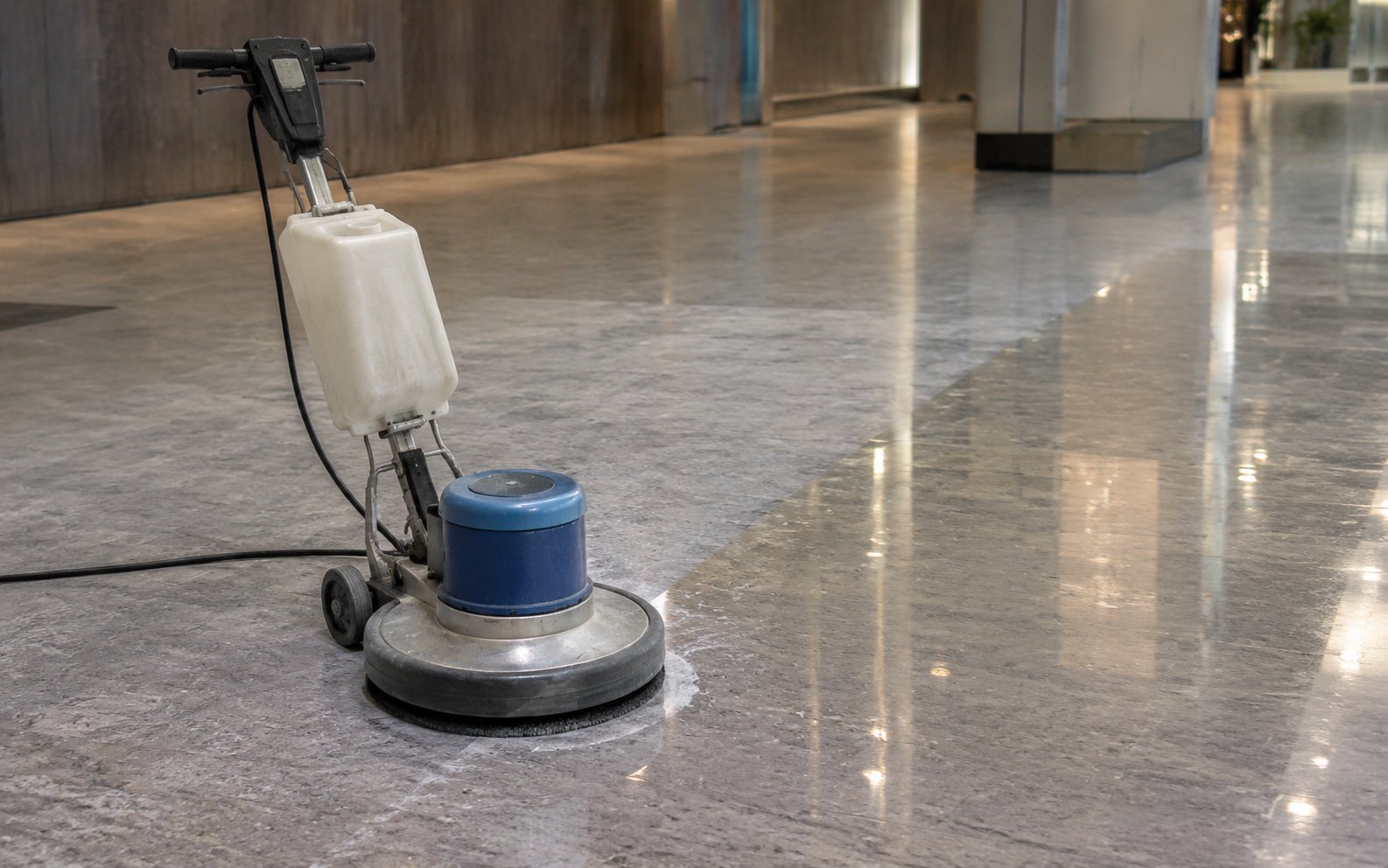 Home A rotary floor polishing machine on a large area of stone flooring